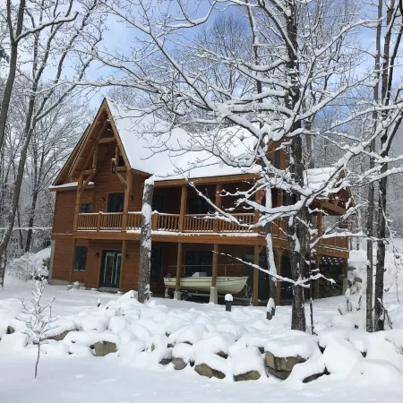 Luxury Log home steps from private beach in Meredith on Lake Winnipesaukee.