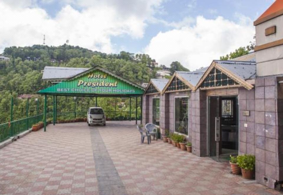 "a car is parked in front of a building with a green canopy that says "" francisco restaurant ""." at Hotel President