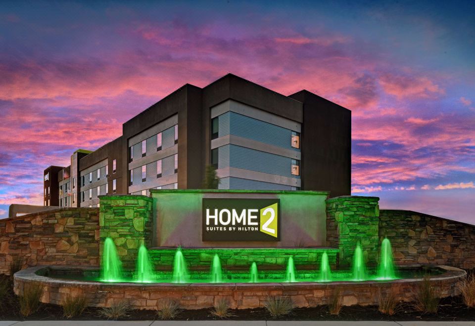 "a large hotel building with a sign that reads "" home 2 "" prominently displayed on the front of the building" at Home2 Suites by Hilton Tracy