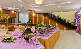 a buffet table filled with a variety of food items , including multiple trays of dishes and bowls at Muong Thanh Dien Chau Hotel