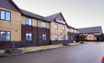 "a brick building with a sign that reads "" premier inn "" on the side of a road" at Premier Inn Blackpool Airport