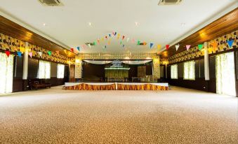 a large room with a stage and a circular setup , decorated with flags and banners at Nakakiri Resort & Spa