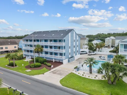 Beach Getaway - First floor unit with Pool and beach access steps away!