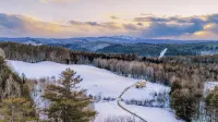 Insanely romantic treehouse perched next to a stream and rolling hills.
