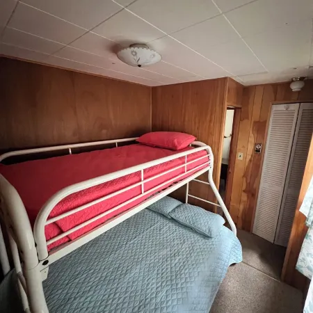 Charming 2-bedroom cabin sits on 2.5 acres on Hubbard Lake.