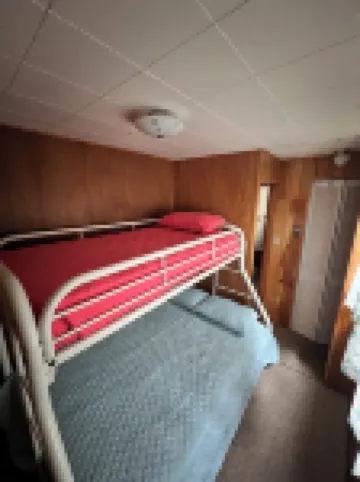 Charming 2-bedroom cabin sits on 2.5 acres on Hubbard Lake.