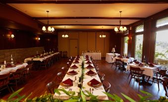 a long dining table set for a formal event , with multiple chairs arranged around it at Cumberland Falls State Resort Park