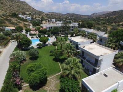 aerial view of a residential area with a pool surrounded by houses , trees , and grass at Valley Village