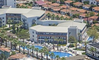 a bird 's eye view of a large resort with multiple buildings and a swimming pool at Palm Wings Kusadasi Beach Resort&Spa