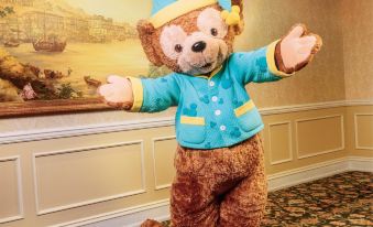 A person in costume stands next to another man dressed as a mascot at Hong Kong Disneyland Hotel