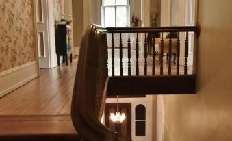a wooden staircase leading up to the second floor of a building , with a door at the top at Shaw Mansion Inn