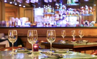 a dining table set for a formal dinner , with wine glasses and utensils arranged neatly on the table at Hotel Frontera Clasico