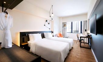 There is a bedroom with double beds and large windows, with an easy-to-access bedside table at Pentahotel Hong Kong, Tuen Mun