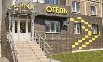 "a modern building with a stone facade and yellow signage , featuring the letters "" otenia "" and "" guss ""." at Luna Hotel