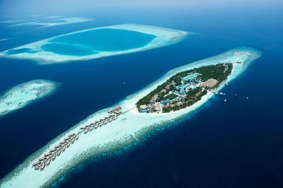 aerial view of a tropical island surrounded by blue water , with a hotel on it at Vilamendhoo Island Resort & Spa