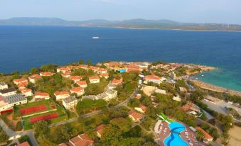 aerial view of a small town by the sea , with a swimming pool and buildings in the background at Club Resort Atlantis