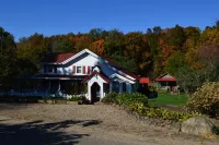 Restored Historical Farmhouse With Pond And Farm Animals At Mohican State Park