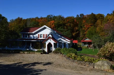 Restored Historical Farmhouse With Pond And Farm Animals At Mohican State Park