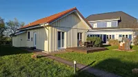 Close to the beach holiday home in a quiet field location with a spacious wooden terrace