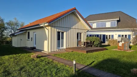 Close to the beach holiday home in a quiet field location with a spacious wooden terrace