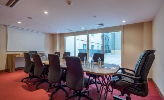 a conference room with a long table and several chairs arranged for a meeting or event at Hampton by Hilton Kahramanmaras
