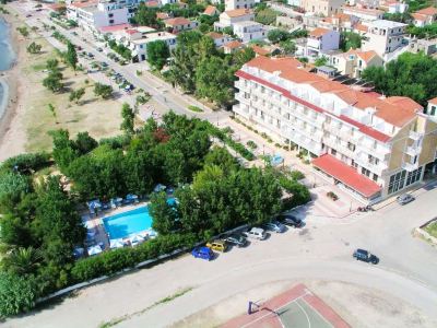 aerial view of a residential area with a swimming pool , tennis court , and multiple buildings at Hotel Summery