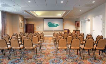 a large conference room with rows of chairs arranged in front of a projector screen , ready for a meeting or presentation at Homewood Suites by Hilton Olmsted Village (Near Pinehurst, NC)