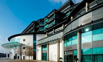 a modern building with a large glass facade and multiple floors , located on a city street at London Twickenham Stadium Hotel, a Member of Radisson Individuals