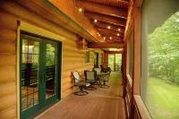 Beautiful log cabin in the woods with a hot tub. 5 min walk to a quiet beach. Hotels in Chippewa County