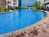 Wooden Accents 1BR at Podomoro City Deli Medan Apartment By Travelio