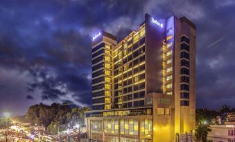 "a large hotel building lit up at night , with the name "" elit hotel "" visible on its sign" at Radisson Blu Gorakhpur