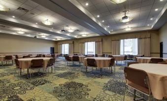 a large conference room with multiple tables and chairs arranged for a meeting or event at Hampton Inn & Suites Denver Littleton