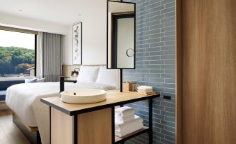 a modern bathroom with a wooden sink , white towels , and a large mirror on the wall at Fairfield by Marriott Tochigi Utsunomiya