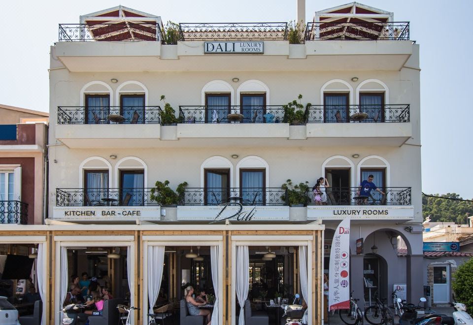 "a large building with a balcony and outdoor dining area , featuring the name "" dal luigi "" and various restaurants" at Dali