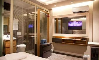 a modern hotel room with a large bed , tv , and a bathroom with a glass door at Upper House Hotel