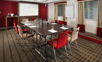 a conference room with a long table and chairs , set up for a meeting or event at Holiday Inn Express London - Dartford