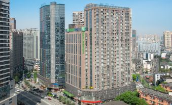 A large building with numerous windows on its side, situated in front of other tall buildings at Holiday Inn Express Chengdu West Gate