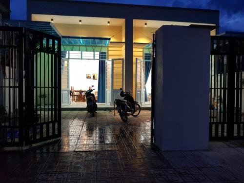 two motorcycles are parked in front of a building at night , with doors leading into the building at Sen Villa Boutique