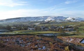 a picturesque rural landscape with snow - covered hills and a small village nestled in the valley at Orchard House Bed and Breakfast