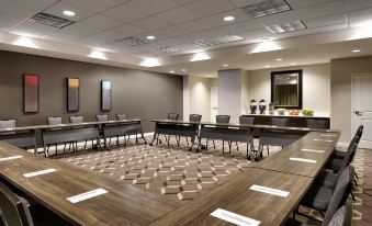 a large conference room with multiple tables , chairs , and a mirror on the wall , ready for a meeting at Residence Inn Greenville
