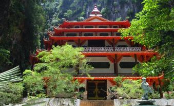 a traditional chinese temple nestled in a mountainous landscape , with lush greenery surrounding it and a stone path leading up to the entrance at Z Hotel