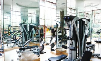 There is a spacious room with multiple exercise machines and a central indoor gym area at Dorsett Shanghai