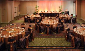 a large dining room with tables and chairs set up for a formal event , possibly a wedding reception at Hilton Garden Inn Tampa/Riverview/Brandon