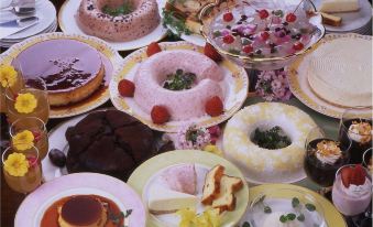 a dining table filled with a variety of desserts , including cakes , pies , and other sweet treats at Stream