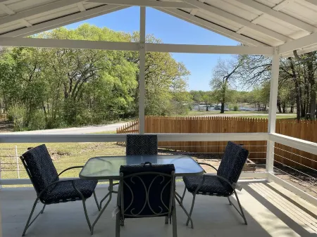 Studio cabin #3 with lake view and boat dock access, outdoor seating.
