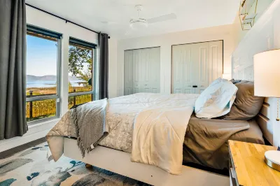 Single-level, lakefront getaway with mini-bar, furnished deck & mountain views
