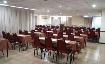a large dining room with multiple tables and chairs set up for a meeting or event at Sanctuary Resort