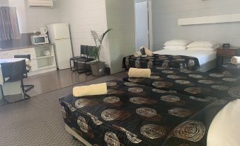 a hotel room with two beds , one on the left and one on the right side of the room at Hillview Motel