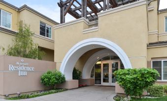 "a building with a large arched entrance and the word "" residence "" written above it , surrounded by greenery" at Residence Inn Palo Alto Los Altos