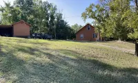 House on 80 acres that connect into the off road park! Extra cabins available.